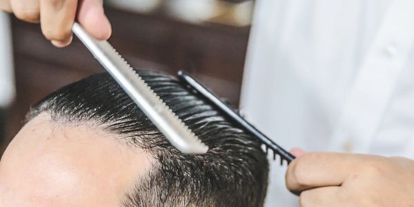 Master barber styling a modern haircut at The British Barbers– best barber for refined grooming