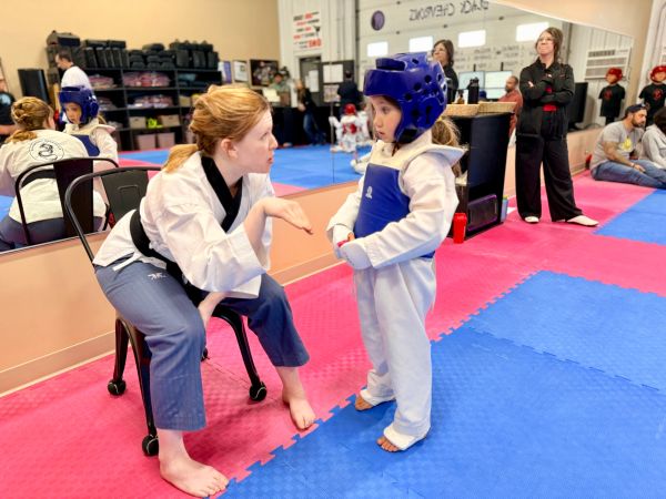 youth taekwondo student with coach at douglas martial arts in moose jaw
