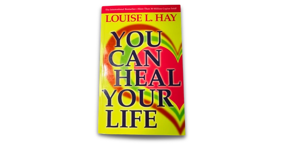 Cover of you can heal your life book. Yellow background with red and green heart