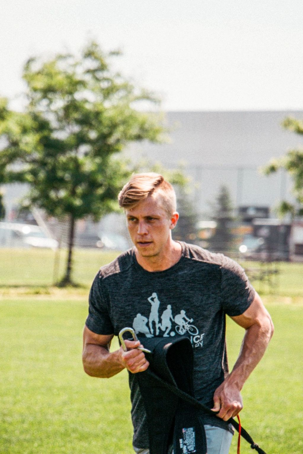 Coach Gabe Rapley standing outdoors on a grass field