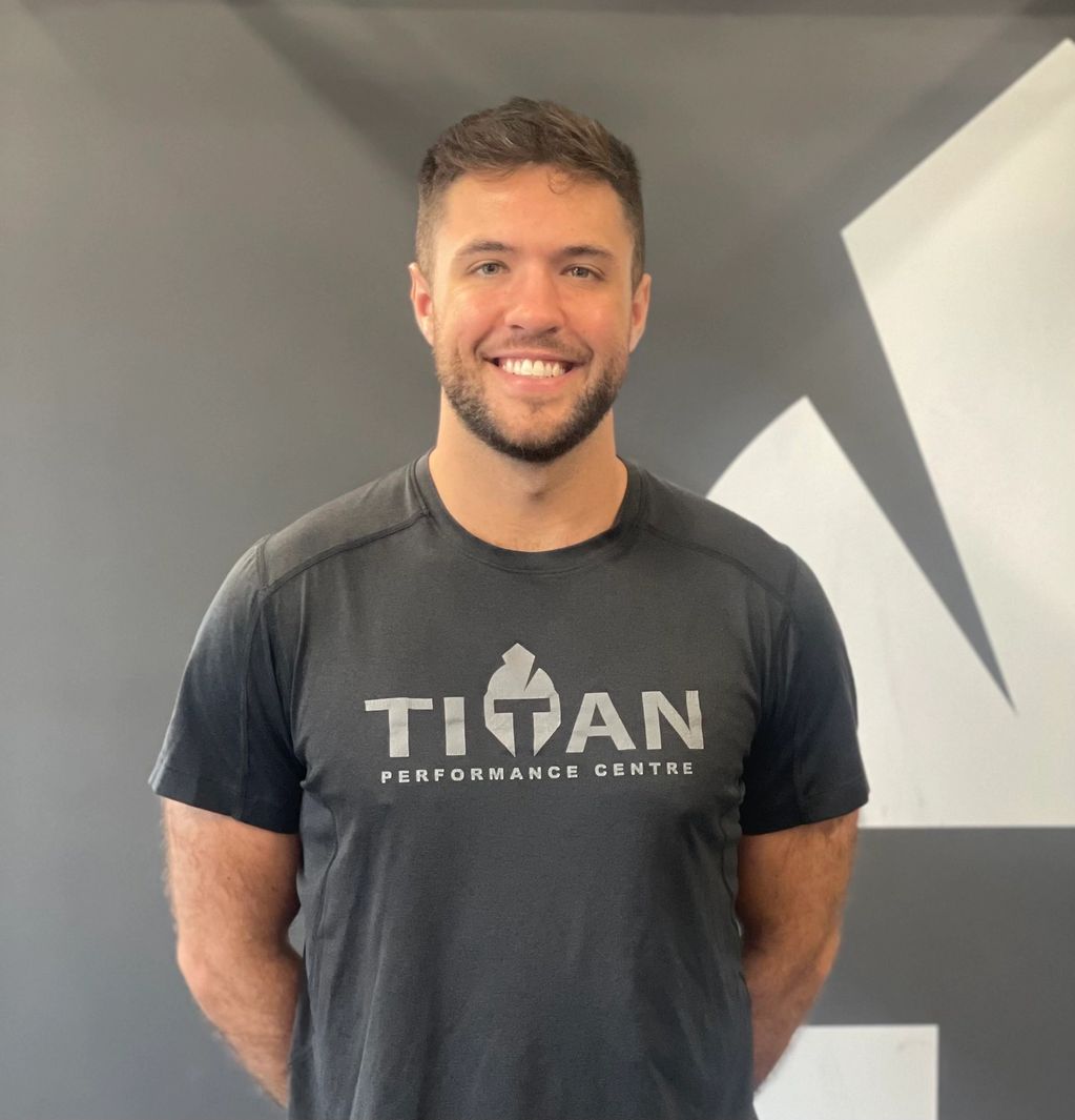 Coach Scotty Leboeuf smiling in a grey Titan t-shirt