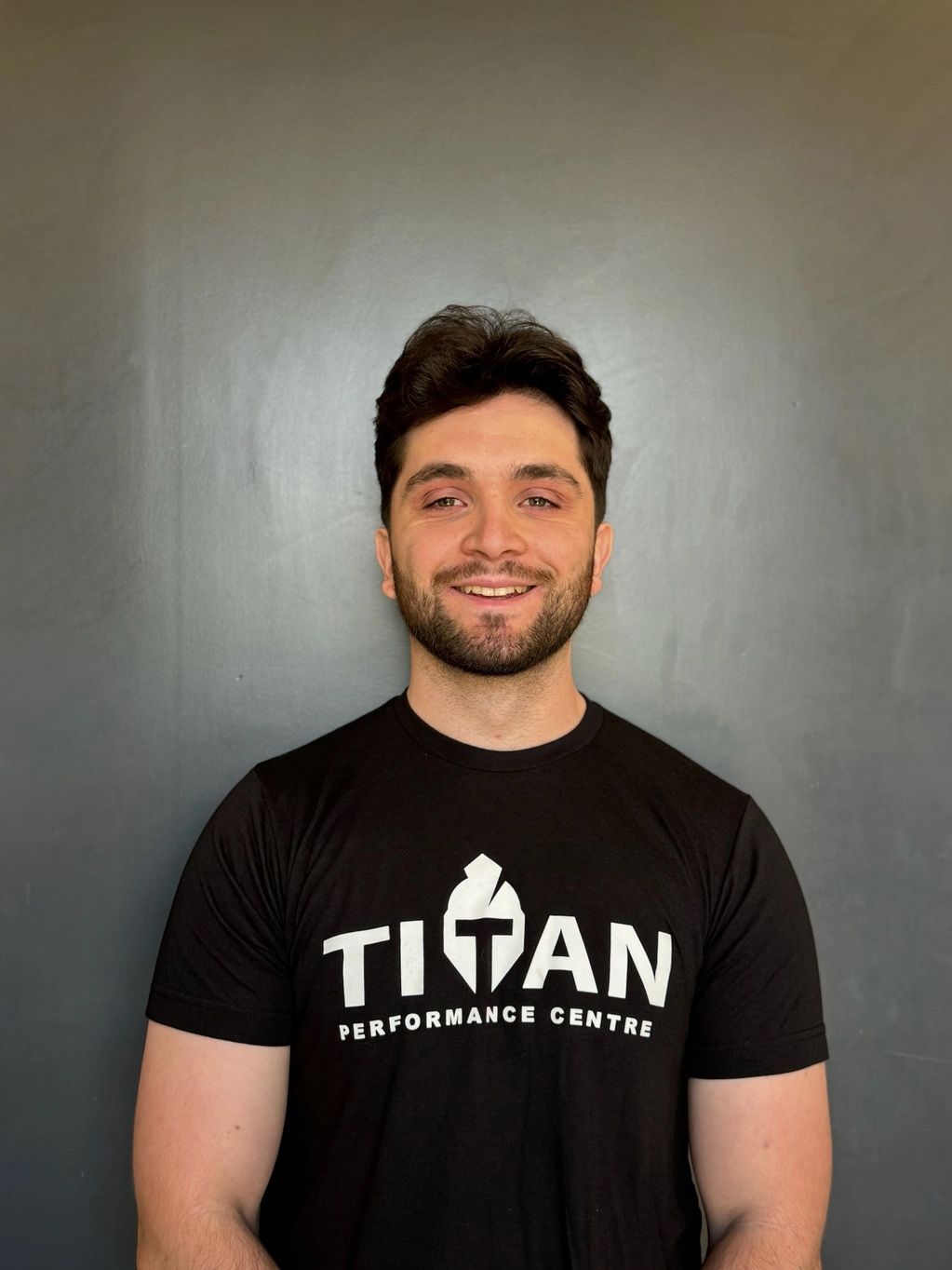 Coach James Martell smiling in a black Titan t-shirt