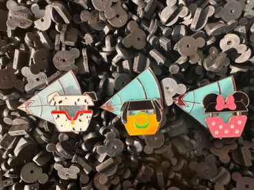 Three colorful pins featuring Disney cable cars and characters.