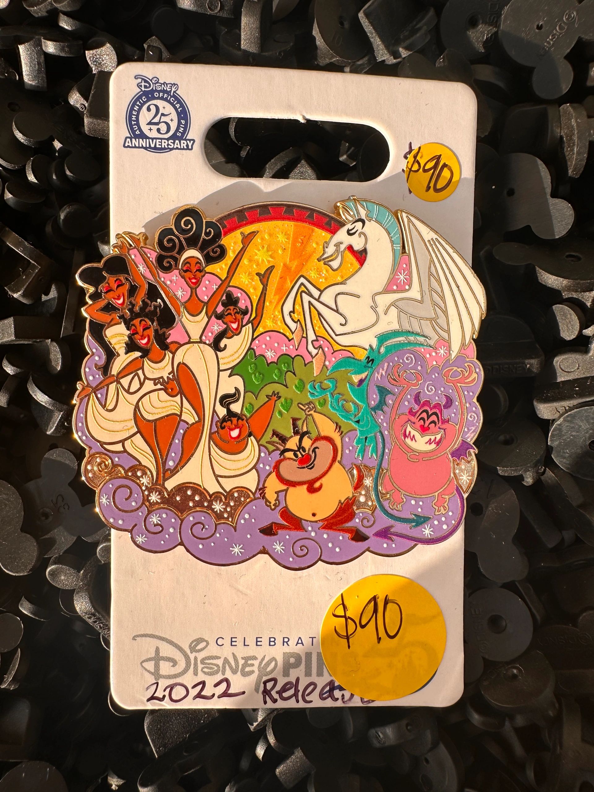 Disney 25th Anniversary pin set with colorful characters.