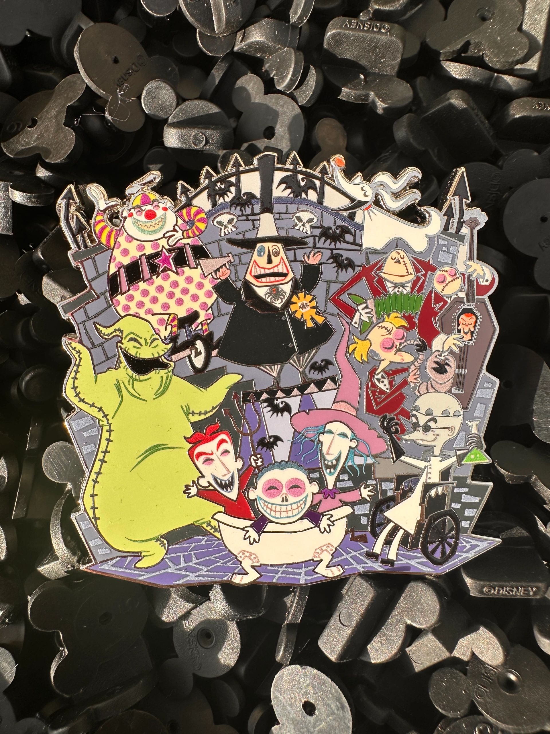 A colorful pin featuring characters from "The Nightmare Before Christmas."