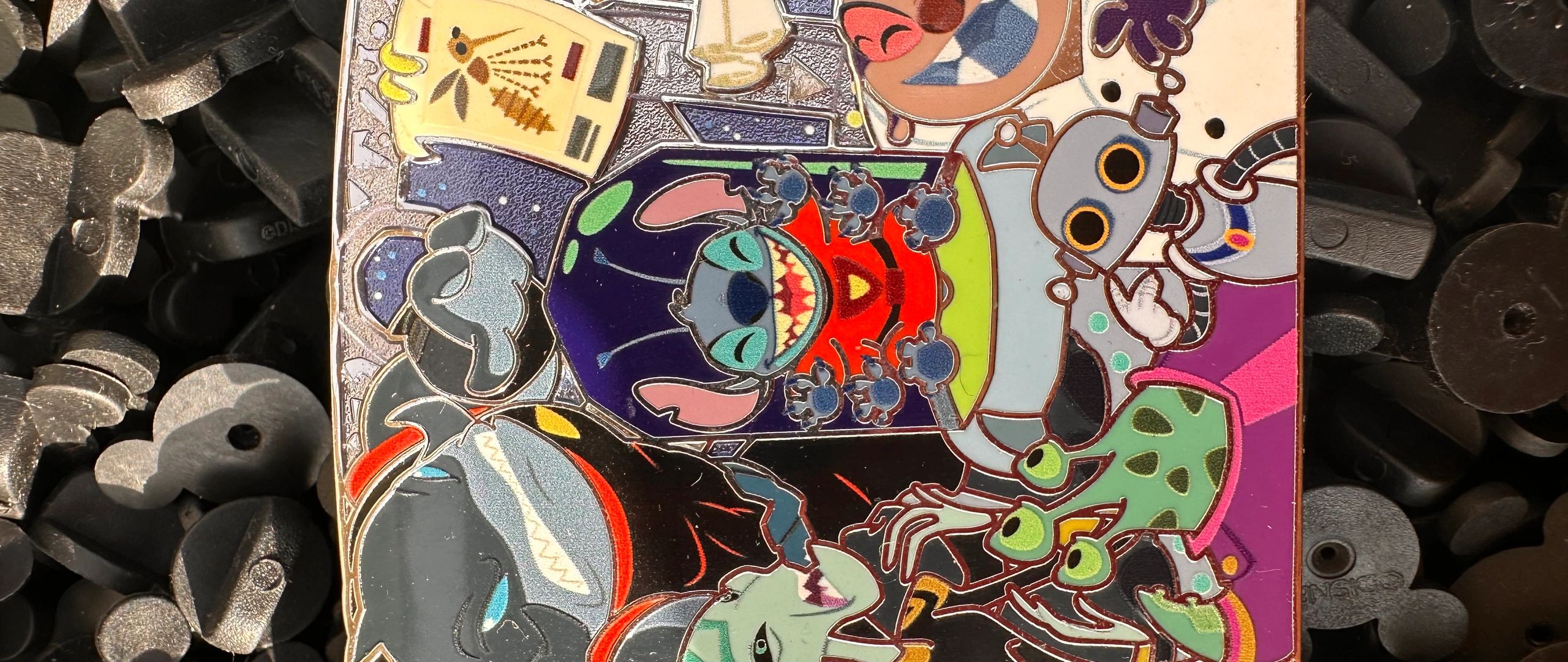 Colorful enamel pin featuring animated characters.