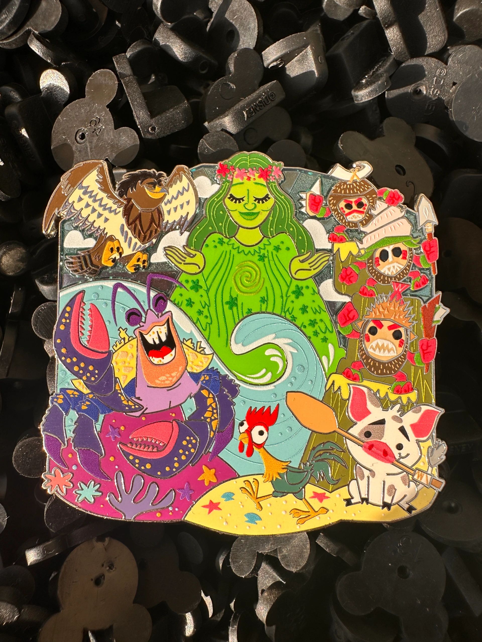 Colorful enamel pin featuring ocean creatures and characters.