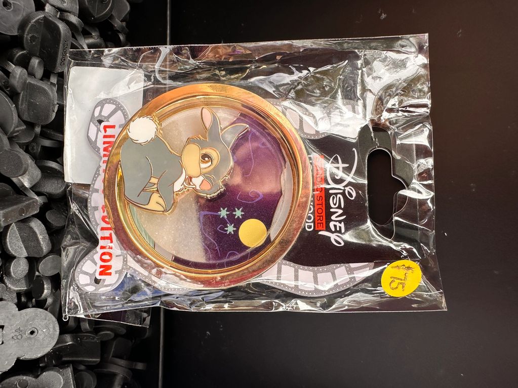 Disney-themed pin with a rabbit wearing a hat in a sealed package.