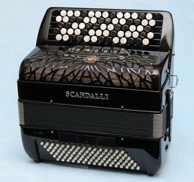 A black Scandalli button accordion with multiple rows of white buttons.