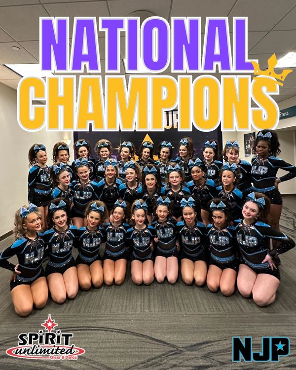 Cheerleading team proudly posing as National Champions with matching uniforms and blue bows.