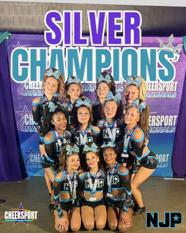 Cheerleading team posing proudly as silver champions at Cheersport Nationals.