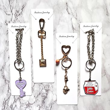 Four decorative keychain accessories with unique charms.