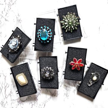 Seven assorted vintage brooches with gems and pearls.