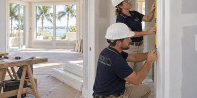 AI illustration: RCN-uniformed tradespeople fitting trim in a new residential build.