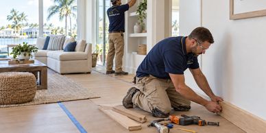 AI illustration: workers in RCN uniforms completing interior trim and home remodeling.
