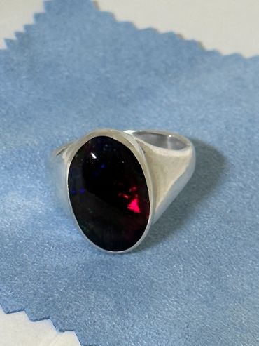 Silver lost-wax cast ring with cabochon set ethopian black opal. 