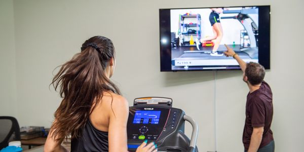 Performaing a running analysis and helping a patient with education. 