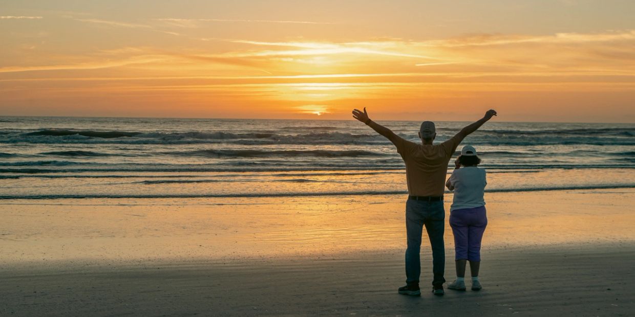 An older couple on a beach after creating a free Memorial Plan with Eternal Legacy. 