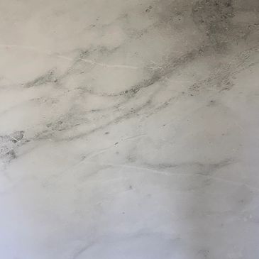 Square marble-patterned tile with rounded corners.