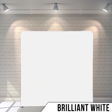 A brilliant white display board illuminated by ceiling spotlights on a brick wall background.