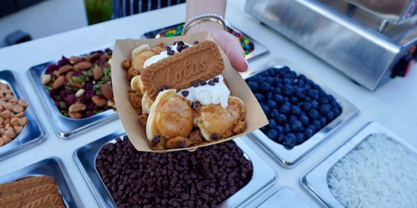 A serene landscape with a sunset over mountains and a calm lake reflecting the colors.