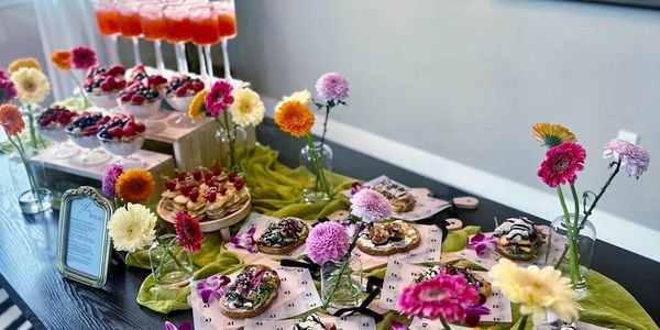 A beautiful sunset over a calm lake with silhouettes of trees in the foreground.