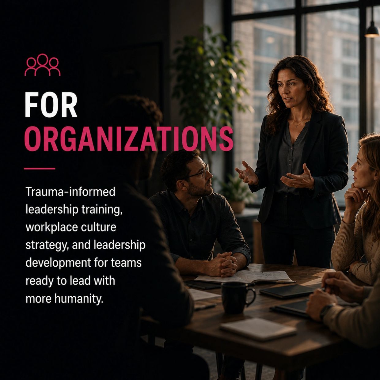 A woman leads a business meeting focused on trauma-informed leadership for organizations.