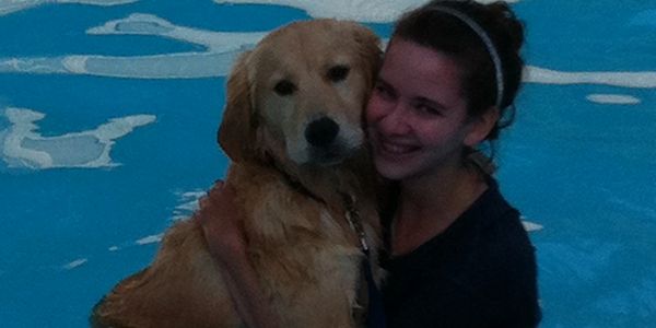 A dog and a woman in the pool