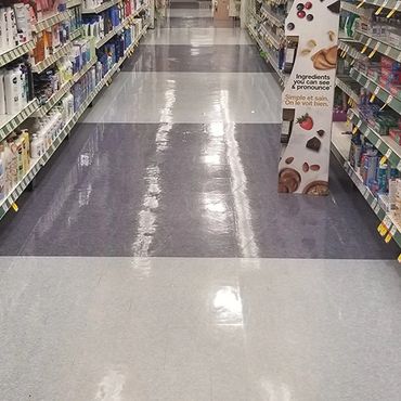 Grocery store aisle with very shiny floors, after being stripped and waxed.