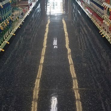 Grocery store aisle with very shiny floors, after being stripped and waxed.