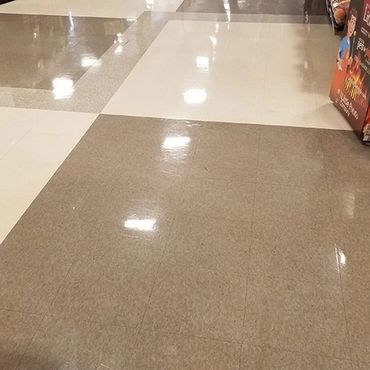 Grocery store aisle with very shiny floors, after being stripped and waxed.