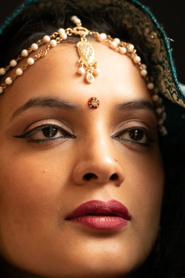 Close-up of a woman with traditional Indian jewelry.