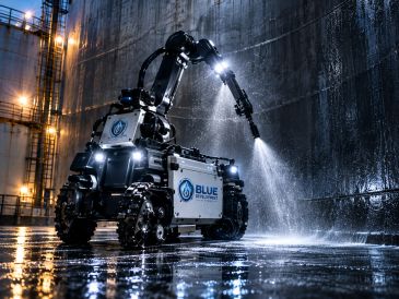 Robot cleaning with water jets in industrial setting.