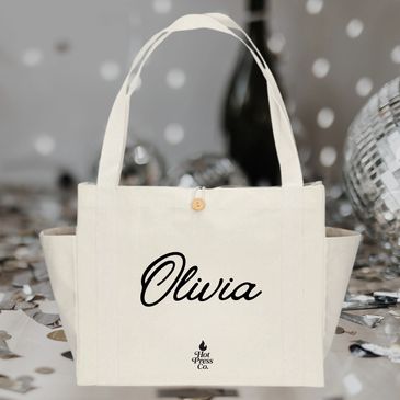 Cream tote bag with the name Olivia printed in black script.