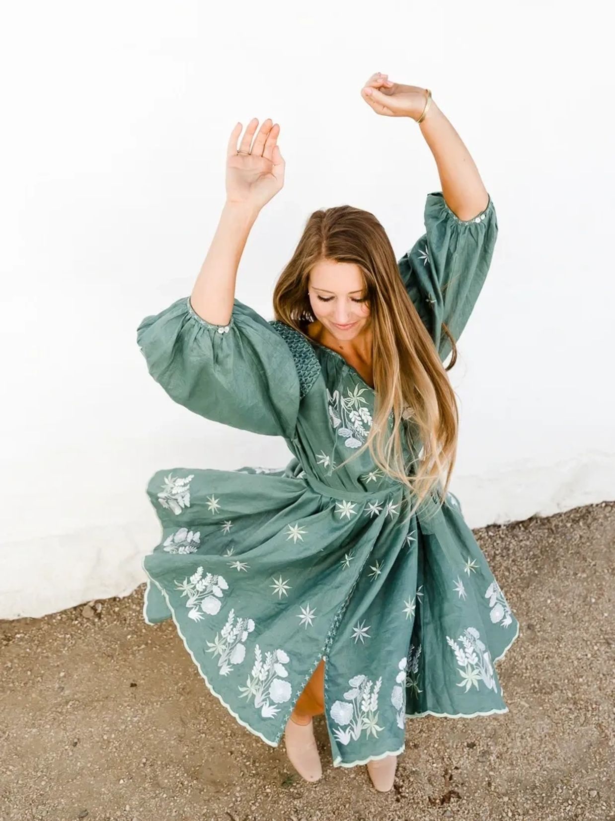 ElizaBeth Alexander Somatic Coach Los Altos CA n a Green Dress arms up in the air twirling