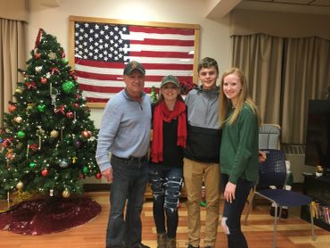 Family Posing in Front of a Christmas Tree