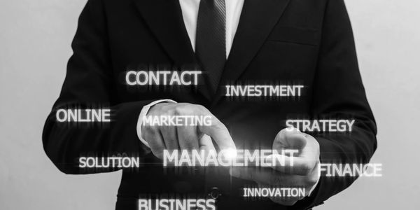 Businessman interacting with virtual management concepts.