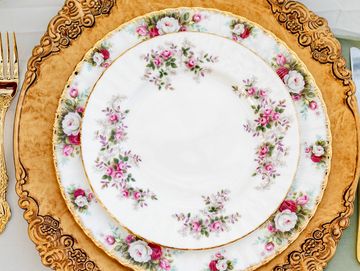 Vintage floral plates on gold charger dinner place setting for micro wedding