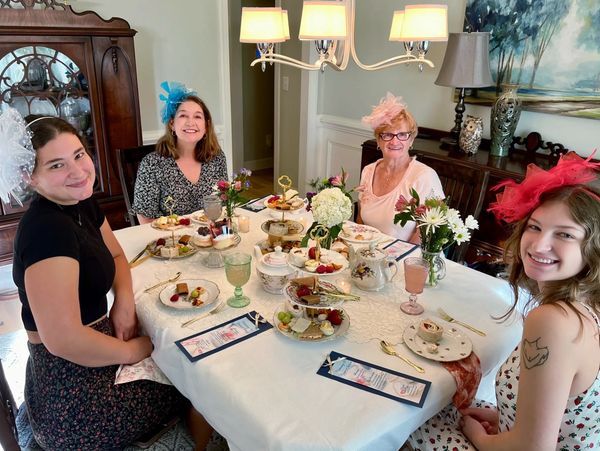 Tea Party with 3 generations of ladies wearing fascinators