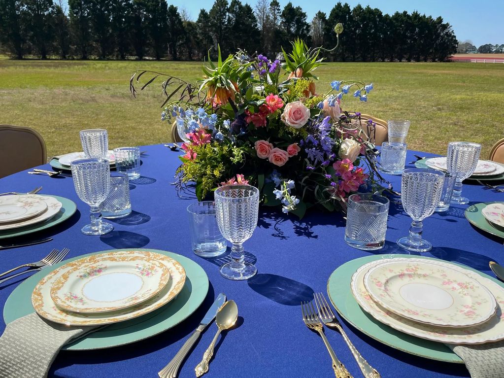 Outdoor dinner table set with vintage china