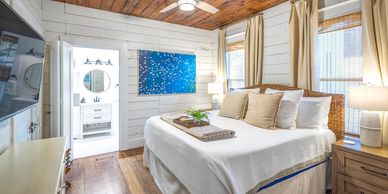 Cozy bedroom with white walls and wood accents.
