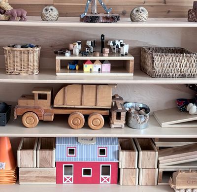 Wooden toys and baskets on shelves.