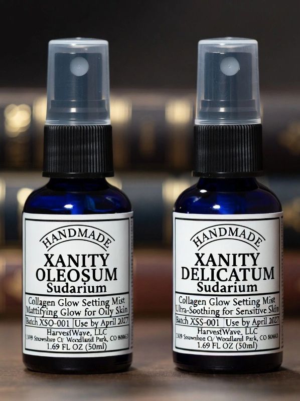 Two blue bottles of handmade collagen glow setting mist for different skin types.
