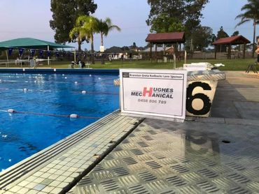 This is a picture of Branxton Pool with Hughes Mechanical's logo on the lane.