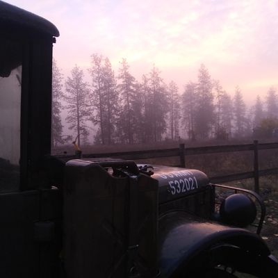 an old army truck in the mist