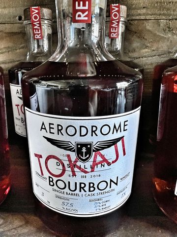Bottle of Aerodrome Top Shelf Bourbon whiskey with detailed label.