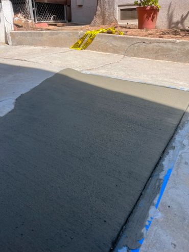 Freshly poured concrete driveway section blocked off with caution tape and an orange traffic Concrete Contractors Near Me, Los Angeles Concrete, Concrete Near Me, Concrete Services Near Me, Concrete Contractor, Concrete Repair, Concrete Contractors, Concrete Driveway Contractors Near Me, Concrete Services, driveways, patios and stairs, garages, sidewalks, walkways concrete.