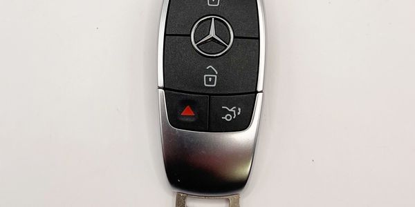 A Mercedes-Benz key fob laying on a wood surface Stock Photo - Alamy