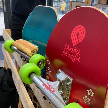 Skateboards hanging on the back of a seat.