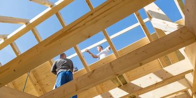 Home under construction with wood framing and blue sky, built by Full Circle Building Group